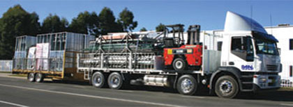Loaded Paal truck with construction equipment