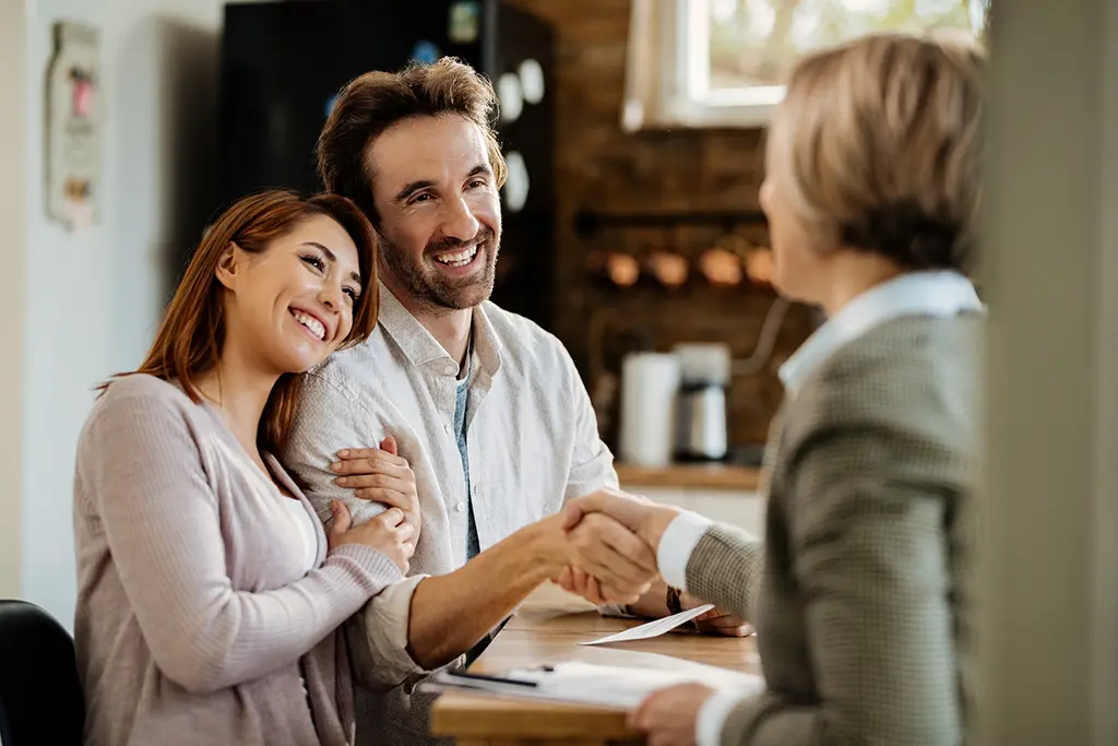 Couple securing a deal with a financial advisor