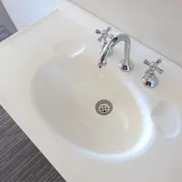 White bathroom sink and vanity with chrome taps