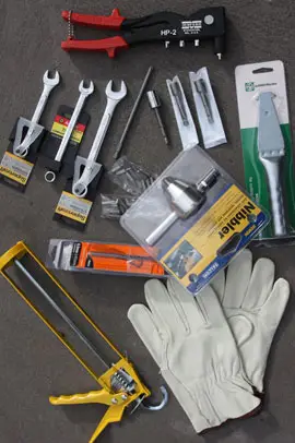 Spanners, drill bits, philips head bits, rivet gun, scoring knife, nut setters, leather gloves.