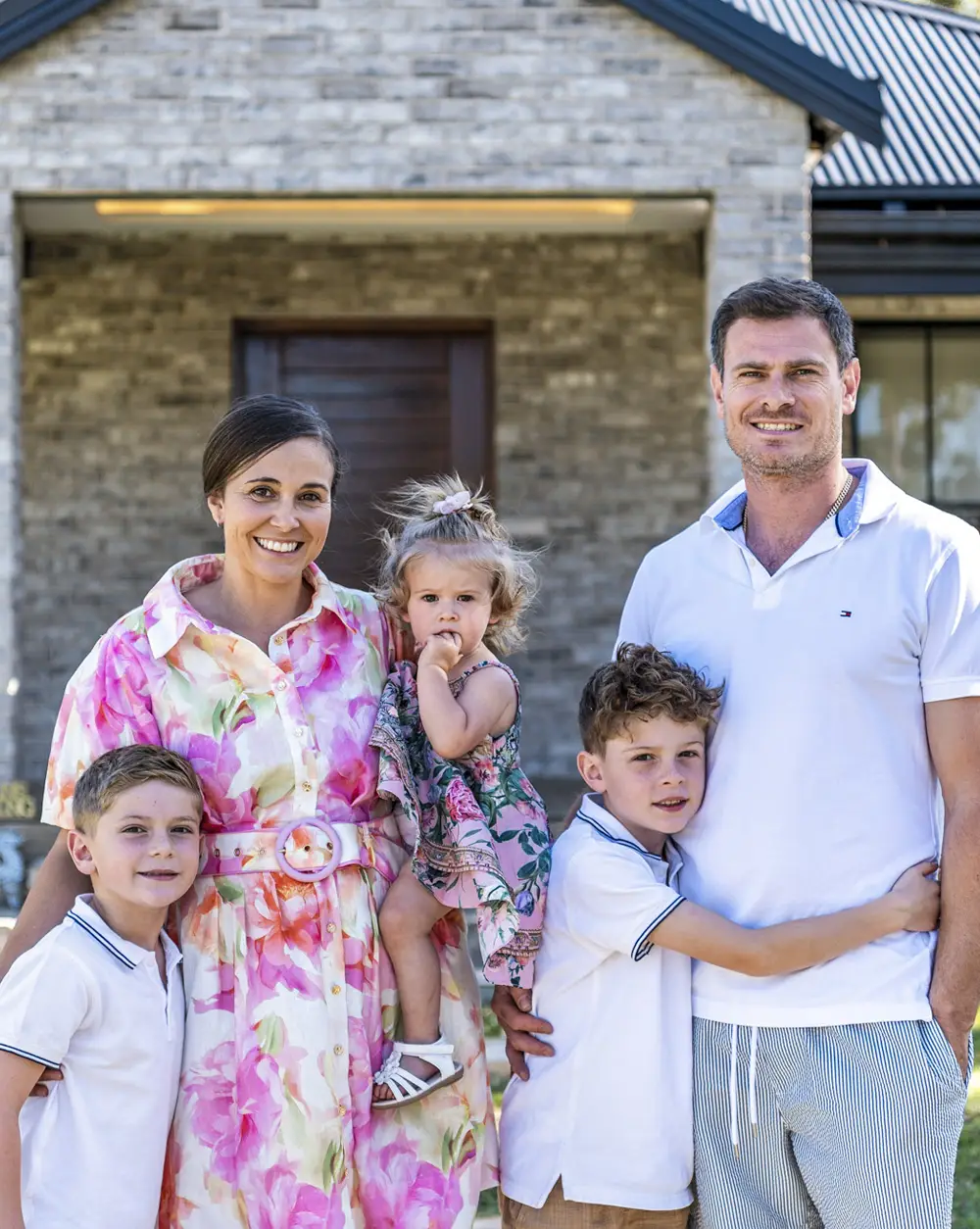 Clinton and Melissa Camilleri family out front of their new kit home