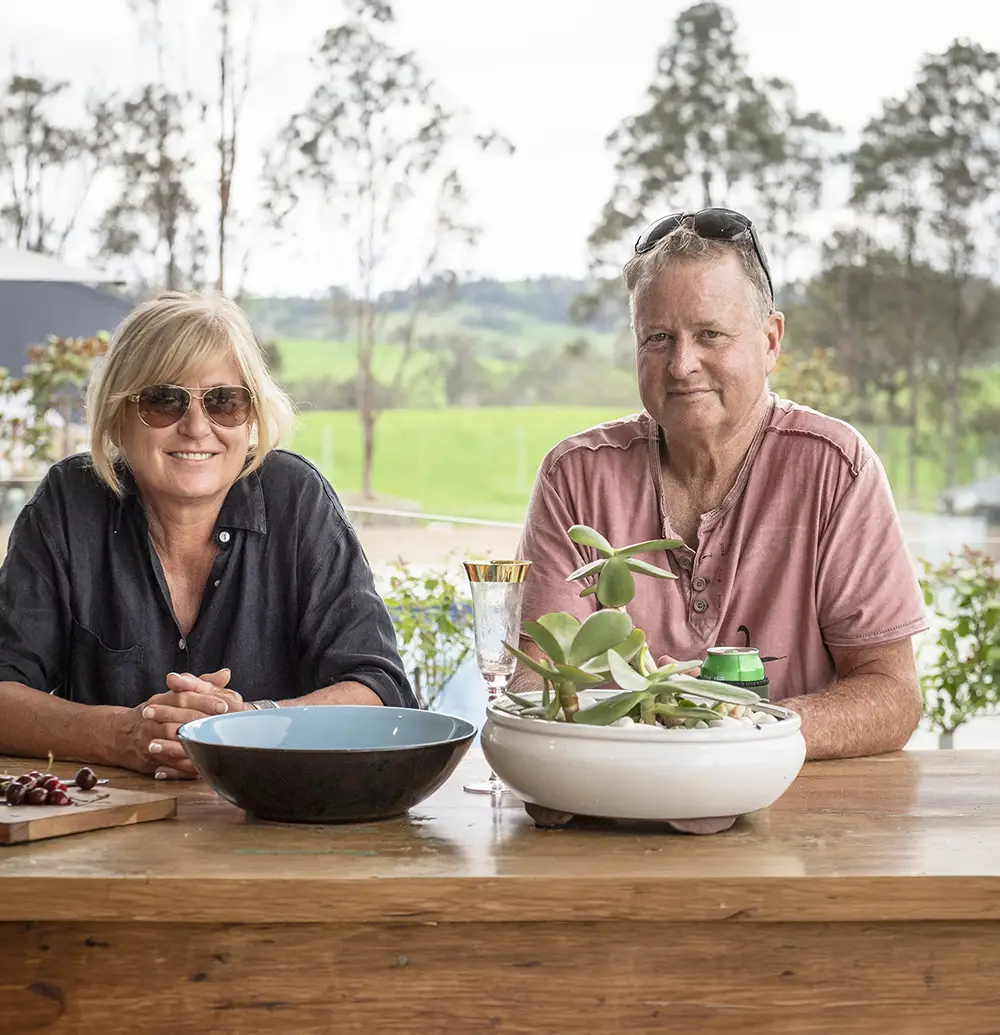 Mick and Lyn sitting at table in front of Richmond